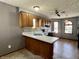 Features wood cabinets, stylish backsplash, a double sink, white countertops, and natural light at 741 Springmill Dr, Mooresville, IN 46158