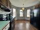Eat-in kitchen nook with bright windows, wood-look flooring, and black appliances at 741 Springmill Dr, Mooresville, IN 46158