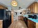 Well-equipped kitchen featuring wood cabinets, laminate flooring, and stainless appliances at 741 Springmill Dr, Mooresville, IN 46158