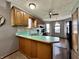 Galley kitchen with a breakfast bar, wood cabinets, and gray walls at 741 Springmill Dr, Mooresville, IN 46158