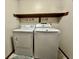Laundry room with a top-load washer and dryer and a shelf for storage at 741 Springmill Dr, Mooresville, IN 46158