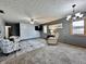 Bright living room with white brick accent wall, neutral decor, and soft carpeting at 741 Springmill Dr, Mooresville, IN 46158
