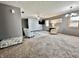 Spacious living room featuring neutral paint, plush carpeting, and a decorative brick accent wall at 741 Springmill Dr, Mooresville, IN 46158