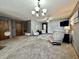 Large living room with gray walls and carpeted floors, featuring two sitting areas at 741 Springmill Dr, Mooresville, IN 46158