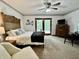 Comfortable bedroom with wooden bed frame, neutral decor, and private outdoor access at 741 Springmill Dr, Mooresville, IN 46158