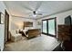 Inviting main bedroom with a decorative wood bed frame, french doors, and plush carpeting at 741 Springmill Dr, Mooresville, IN 46158