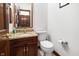 Cozy half bathroom featuring granite countertop and wood vanity at 742 Marana Dr, Carmel, IN 46032