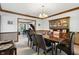 Dining room includes wood trim, dining table and hutch, and a view into a sitting room with piano at 742 Marana Dr, Carmel, IN 46032
