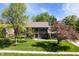 Charming two-story brick home with lush landscaping, mature trees, and a well-manicured lawn at 742 Marana Dr, Carmel, IN 46032