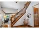 Foyer with hardwood floors, staircase, and a view into the living room at 742 Marana Dr, Carmel, IN 46032