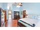 Bright main bedroom with hardwood floors, tall ceilings, a ceiling fan, and access to an ensuite bathroom at 742 Marana Dr, Carmel, IN 46032