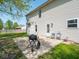 Home's backyard featuring a patio, grill, and easy access to a door to the interior of the home at 7611 Penguin Cir, Indianapolis, IN 46239