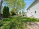 Spacious backyard with lush lawn, mature trees, and a patio area perfect for outdoor entertaining at 7611 Penguin Cir, Indianapolis, IN 46239