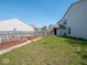 Backyard showing lawn, raised garden beds, and wooden fencing around the perimeter at 7611 Penguin Cir, Indianapolis, IN 46239