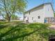An expansive backyard featuring green grass and patio with a grill for outdoor cooking at 7611 Penguin Cir, Indianapolis, IN 46239