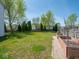 Beautiful backyard with mature trees, green grass and raised garden beds at 7611 Penguin Cir, Indianapolis, IN 46239