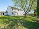 Spacious backyard featuring mature trees and a lush green lawn at 7611 Penguin Cir, Indianapolis, IN 46239