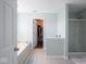 Bathroom features a soaking tub, walk-in shower, and walk-in closet at 7611 Penguin Cir, Indianapolis, IN 46239