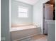 Bright bathroom showcasing a built-in tub and a window for natural light at 7611 Penguin Cir, Indianapolis, IN 46239
