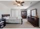 Inviting bedroom with carpet, ceiling fan, a wardrobe cabinet and a dresser at 7611 Penguin Cir, Indianapolis, IN 46239
