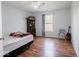Simple bedroom with hardwood floors, natural light, and neutral tones creating a relaxing atmosphere at 7611 Penguin Cir, Indianapolis, IN 46239