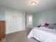 Comfortable bedroom with double closet, light-blue walls, and plush carpeting at 7611 Penguin Cir, Indianapolis, IN 46239
