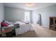 Cozy bedroom featuring light-blue walls, plush carpeting, and a sunny window at 7611 Penguin Cir, Indianapolis, IN 46239