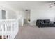 Bright bonus room with gray sofa, neutral walls, and plush carpeting at 7611 Penguin Cir, Indianapolis, IN 46239