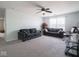 A comfortable bonus room featuring carpeting, sofas, and natural light at 7611 Penguin Cir, Indianapolis, IN 46239