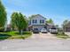 Charming two-story home with a well-manicured lawn, driveway, and beautiful landscaping at 7611 Penguin Cir, Indianapolis, IN 46239