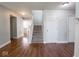 Open foyer with hardwood flooring, a staircase, and neutral paint at 7611 Penguin Cir, Indianapolis, IN 46239