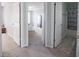 Hallway with doorways leading to a bedroom and a bathroom; neutral wall colors at 7611 Penguin Cir, Indianapolis, IN 46239