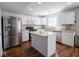 Eat-in kitchen features a stainless steel refrigerator and a kitchen island at 7611 Penguin Cir, Indianapolis, IN 46239
