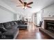 Open-concept living room boasts hardwood floors, a fireplace, and seamless flow into the kitchen at 7611 Penguin Cir, Indianapolis, IN 46239
