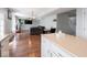Open kitchen, dining, and living space with hardwood floors at 7611 Penguin Cir, Indianapolis, IN 46239