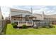 Backyard featuring an above ground pool with deck, covered patio, and green grass at 7643 Belmac Ln, Camby, IN 46113