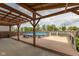 Backyard with a covered wood deck and an above-ground pool with a safety fence at 7643 Belmac Ln, Camby, IN 46113
