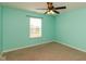 Bedroom features carpet flooring, a ceiling fan, and a window with natural light at 7643 Belmac Ln, Camby, IN 46113