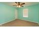 Bedroom features carpet flooring, a ceiling fan, and a window with natural light at 7643 Belmac Ln, Camby, IN 46113