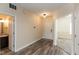 Charming entryway with wood-look flooring, leading to the bathroom and a carpeted room with wainscoting at 7643 Belmac Ln, Camby, IN 46113