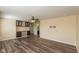 Bright living room featuring wood floors, a ceiling fan, and built-in shelving at 7643 Belmac Ln, Camby, IN 46113