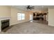 Open concept living room with fireplace flows into a modern kitchen with stainless steel appliances at 7643 Belmac Ln, Camby, IN 46113