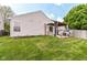 Spacious backyard featuring green grass, a pergola with shade cover, and a wood fence at 8141 Maple Stream Ln, Indianapolis, IN 46217