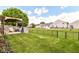 Large backyard with a pergola, covered outdoor seating, and a black chainlink fence at 8141 Maple Stream Ln, Indianapolis, IN 46217