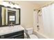 Well-lit bathroom featuring a sink, toilet, shower and a vanity with a framed mirror at 8141 Maple Stream Ln, Indianapolis, IN 46217
