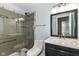 Bathroom featuring a glass-enclosed shower, modern vanity, and updated fixtures at 8141 Maple Stream Ln, Indianapolis, IN 46217
