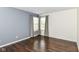 Bedroom with hardwood floors, neutral walls, and large windows at 8141 Maple Stream Ln, Indianapolis, IN 46217