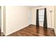 Bedroom featuring hardwood floors, a window with curtains and blinds, and overhead lighting at 8141 Maple Stream Ln, Indianapolis, IN 46217