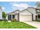 Welcoming home with a two-car garage and a well-maintained lawn, ideal for Gathering living at 8141 Maple Stream Ln, Indianapolis, IN 46217