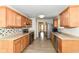 Bright kitchen featuring stainless steel appliances, stylish backsplash, and wood cabinets at 8141 Maple Stream Ln, Indianapolis, IN 46217